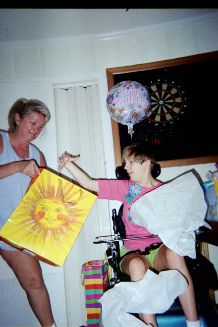 Connie helping Brantley open birthday gift 2003